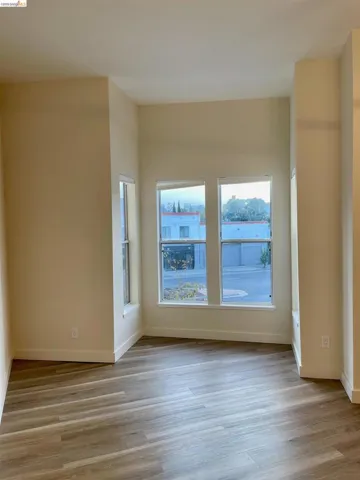 Spare room featuring light wood-type flooring and baseboards