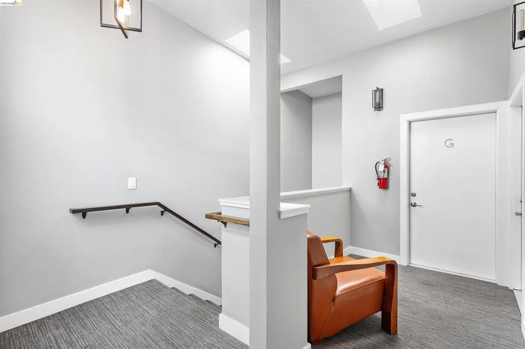 Stairs featuring carpet floors and a skylight