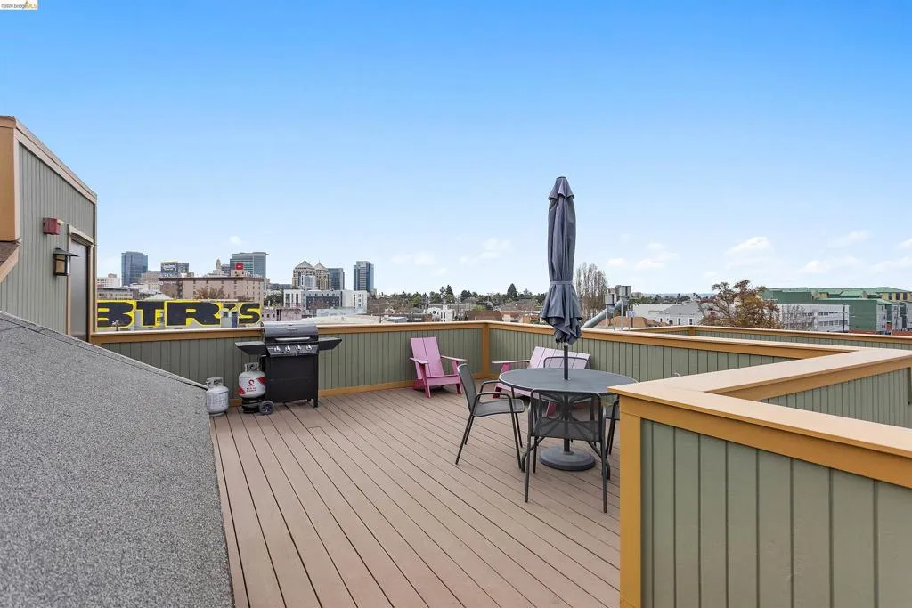 Deck featuring area for grilling, a view of city, and outdoor dining space
