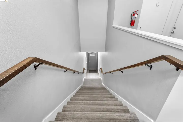 Stairway featuring a textured wall