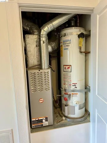 Utility room with water heater and heating unit