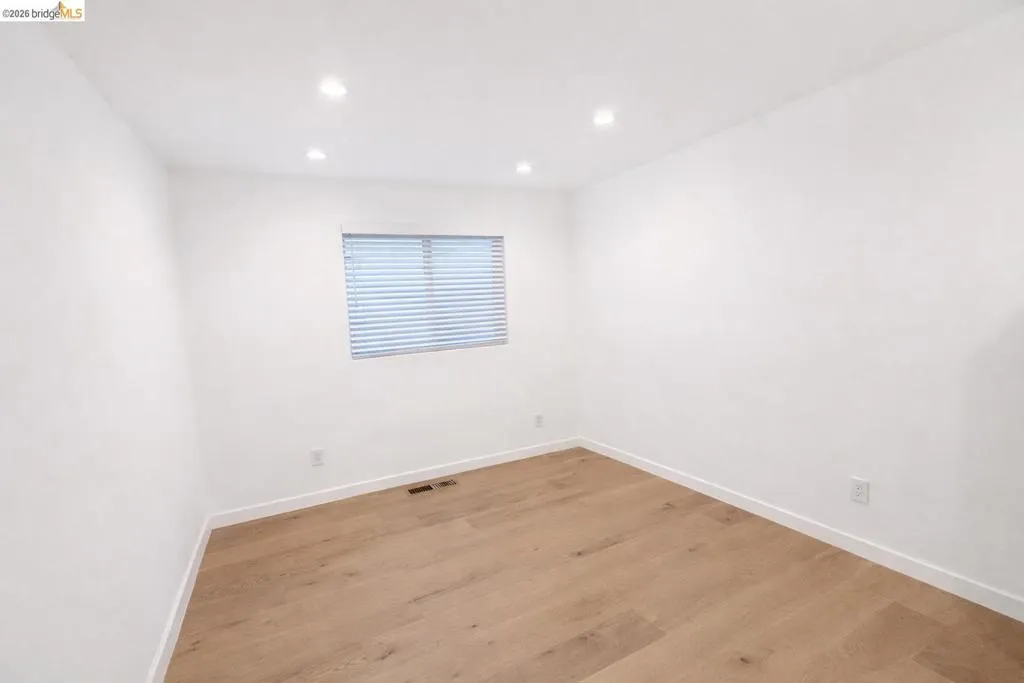 Unfurnished room featuring light wood-style flooring and recessed lighting