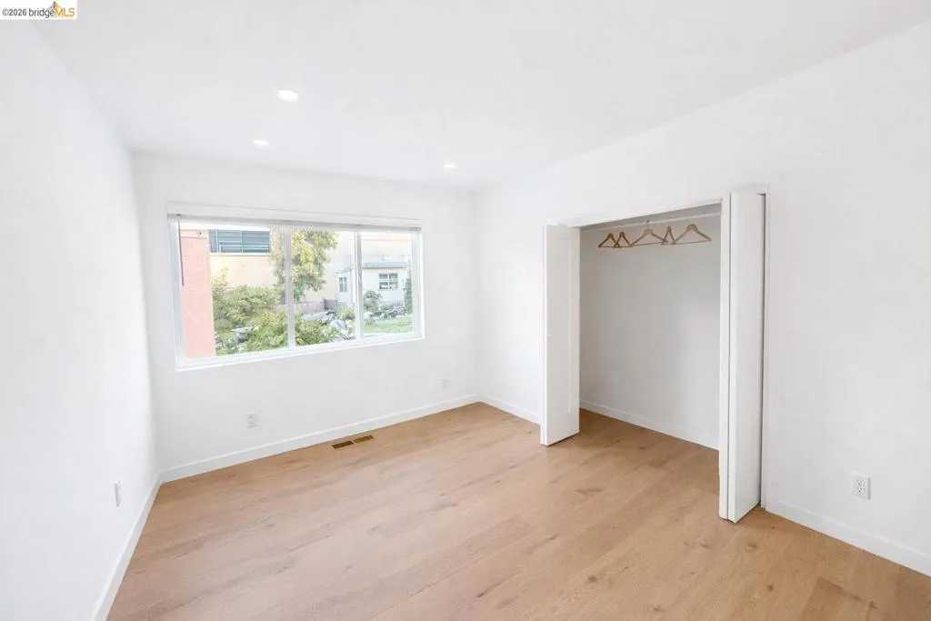 Unfurnished bedroom with light wood-style flooring, a closet, and recessed lighting