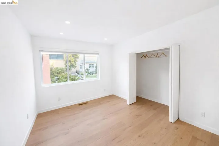 Unfurnished bedroom with light wood-style flooring, a closet, and recessed lighting