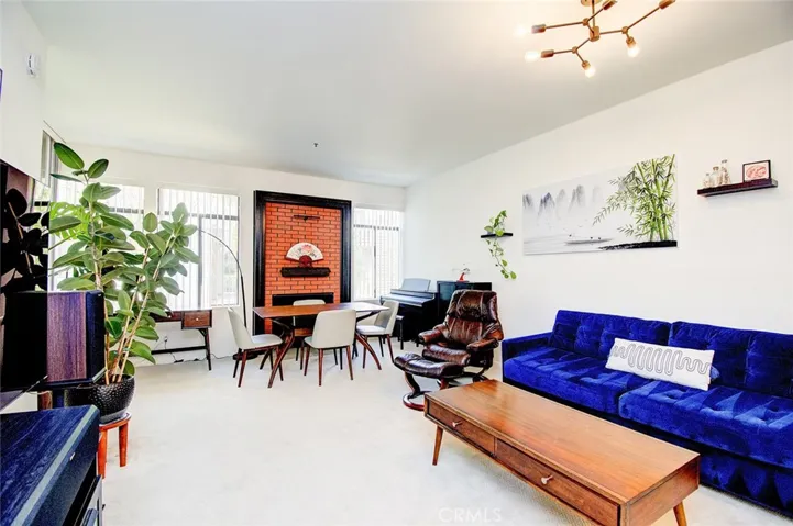 The light and bright living and dining room with a wall of windows and fireplace to anchor this space.