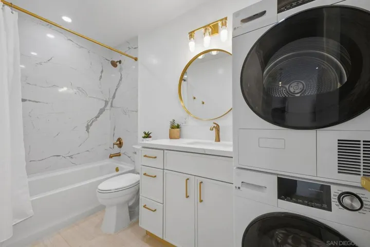 Modern upgraded bathroom with quartz slab shower & in unit washer/dryer!