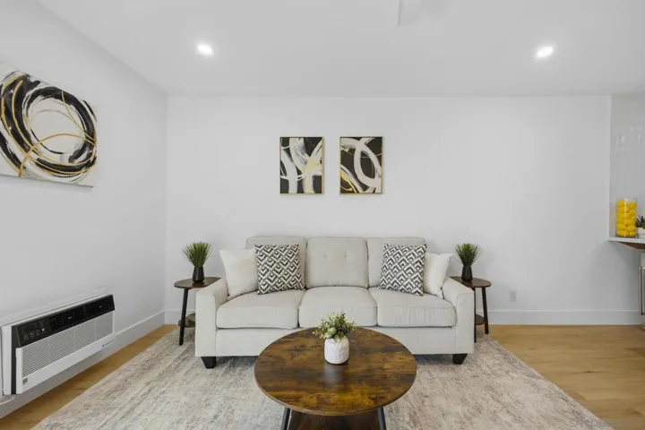 Spacious living room with dual pane windows, recessed lights & ceiling fan