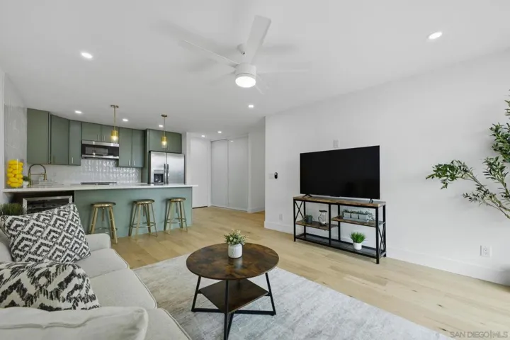 Spacious living room with dual pane windows, recessed lights & ceiling fan
