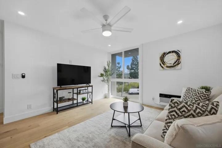 Spacious living room with dual pane windows, recessed lights & ceiling fan