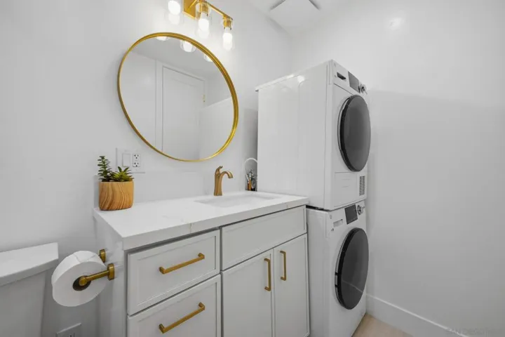 Modern upgraded bathroom with quartz slab shower & in unit washer/dryer!