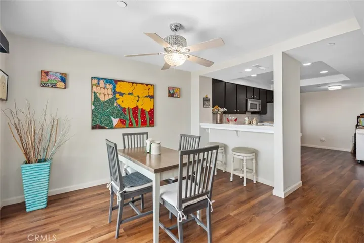 Crystal Ceiling fan and light. Open bar to the kitchen.