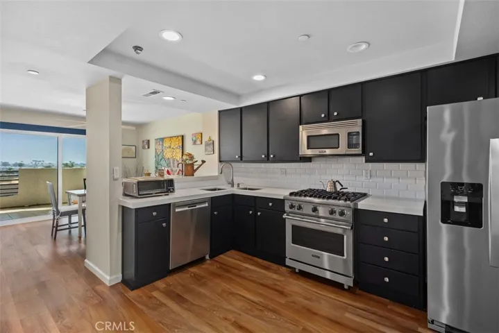 Quartz countertops with the black cabinets. Dual sink with unique design.