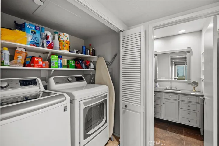 Washer and dryer in entry to guest bathroom.