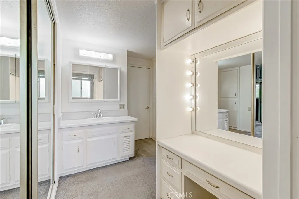 Master bathroom area with mirrored closet doors