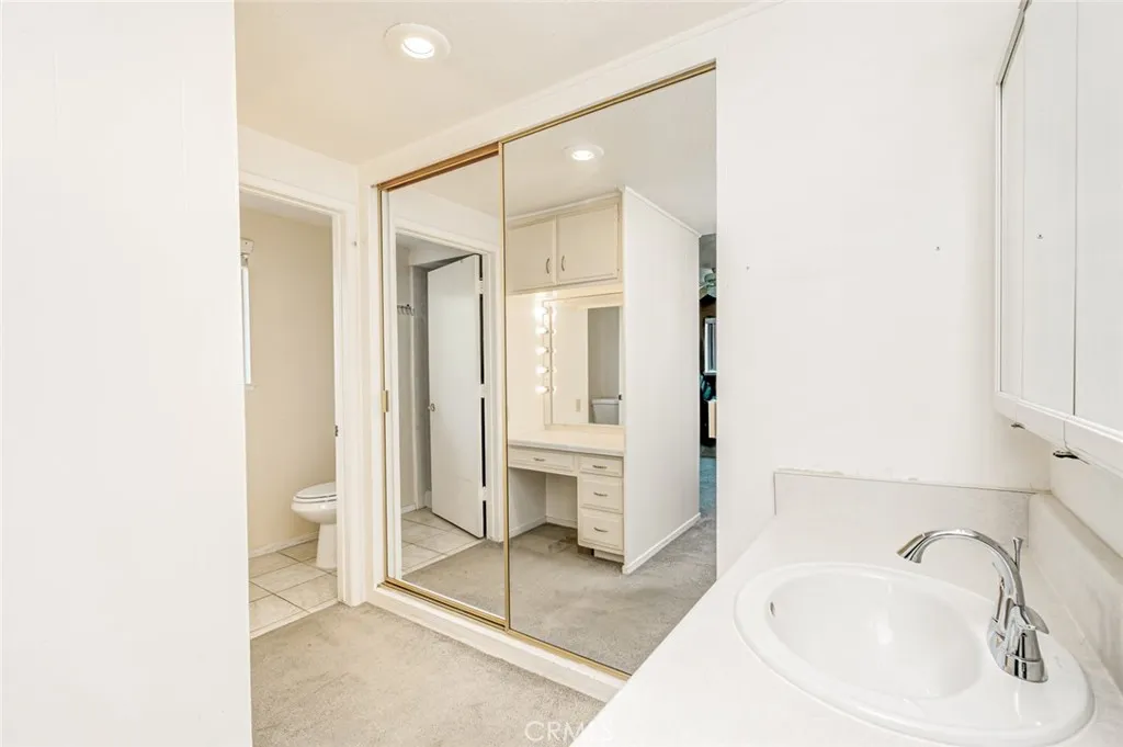 Master bathroom area with mirrored closet doors