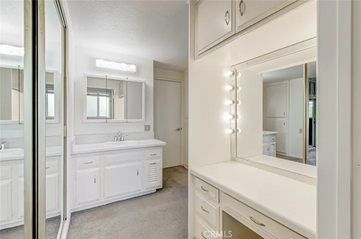 Master bathroom area with mirrored closet doors