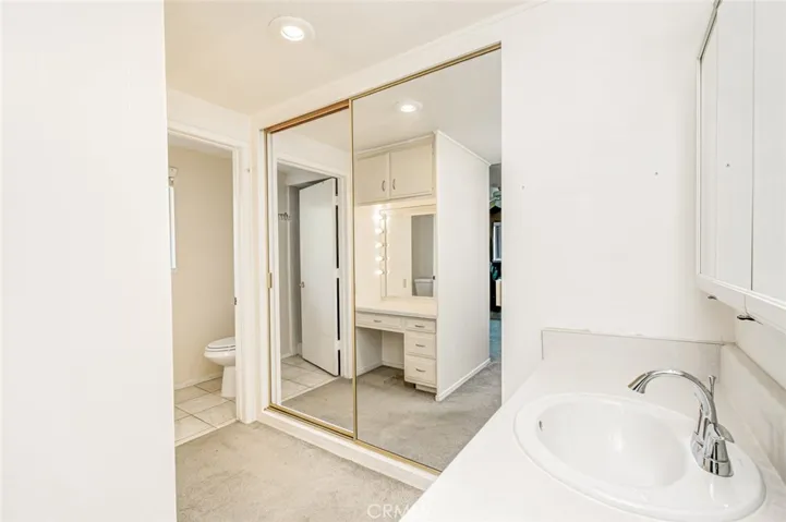 Master bathroom area with mirrored closet doors