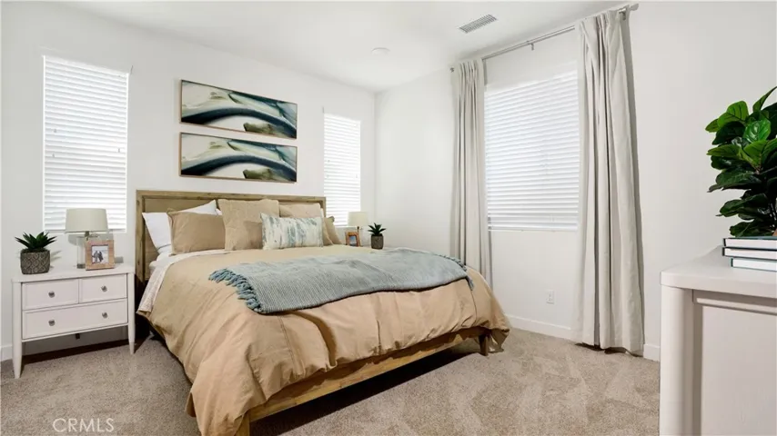the primary bedroom includes a king size bed, nightstands, and dresser