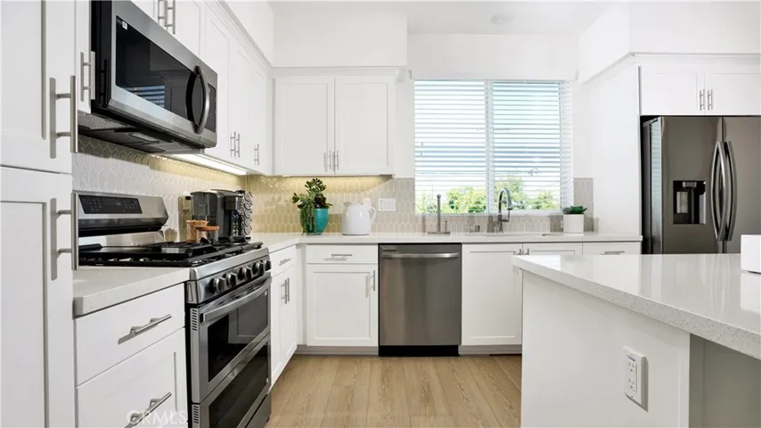 the kitchen includes stainless steel appliances including the referigerator