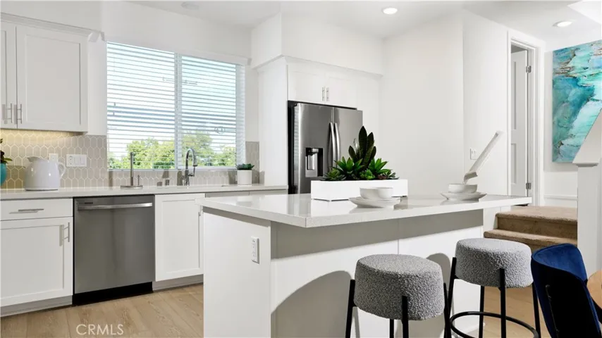 the island at the kitchen gives extra counter space and the perfect place to enjoy a meal
