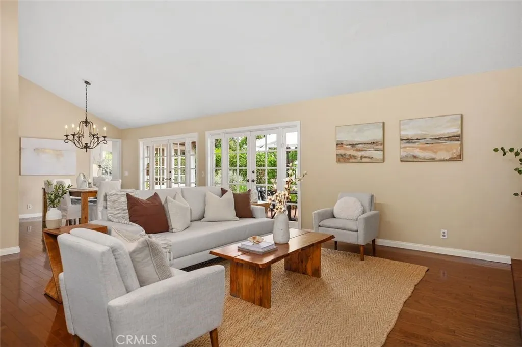 Living room is open to the formal dining area and includes french doors.