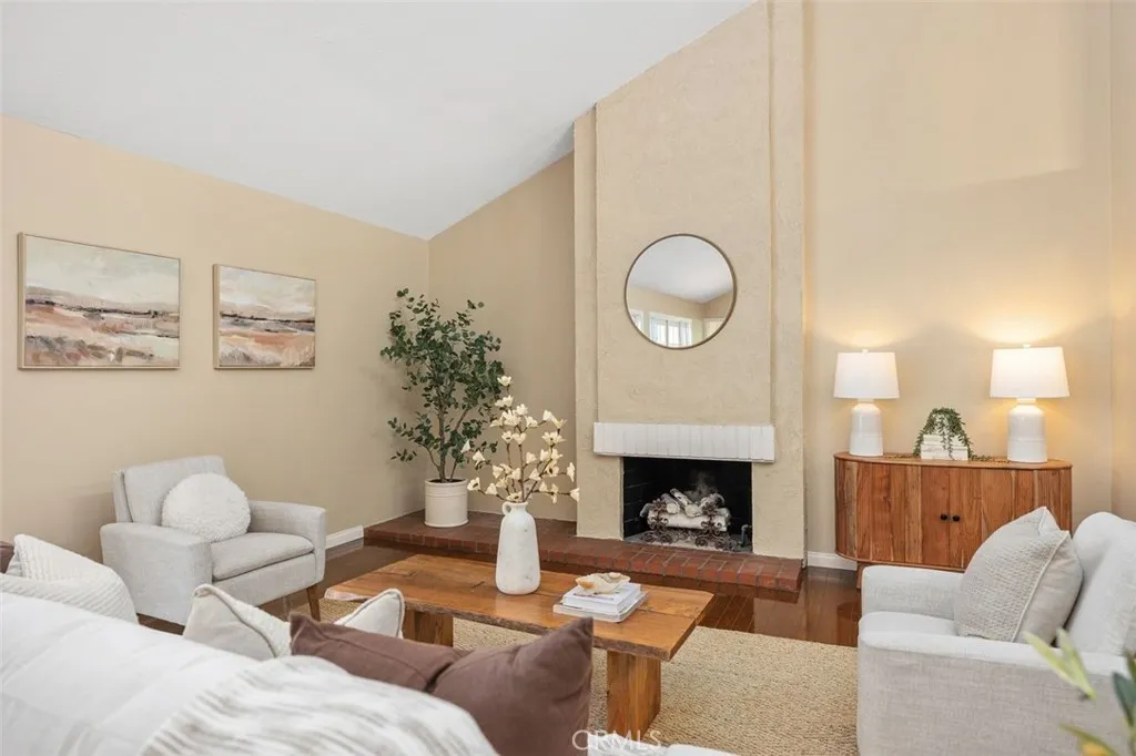 Living room with vaulted ceilings and fireplace.