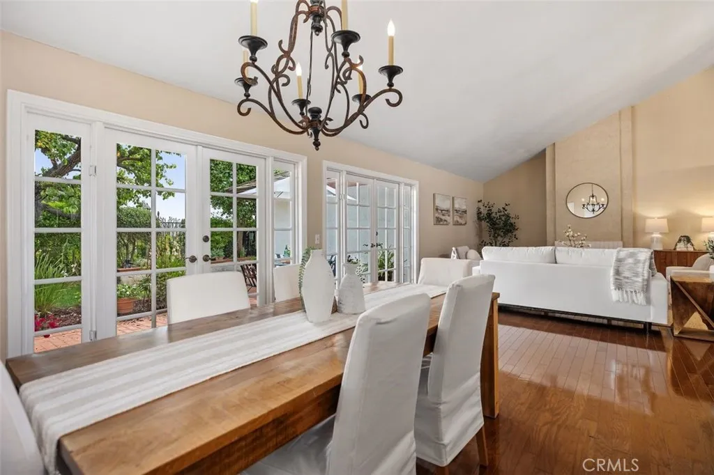 Formal dining area with french doors leading outside to one of the patio gardens.