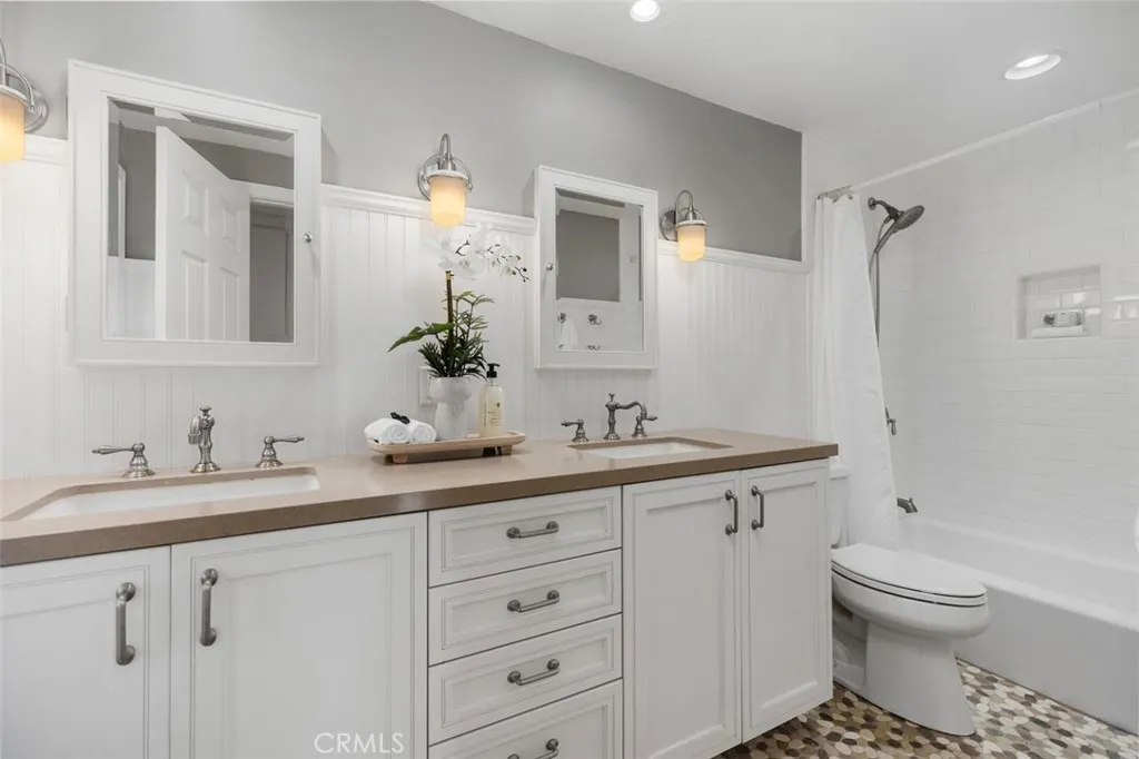 Guest bathroom #2 with dual vanity areas and tub/shower.