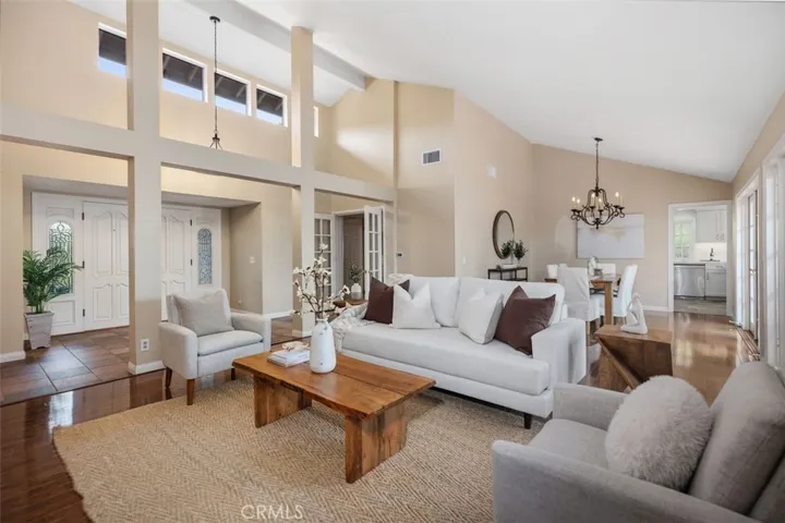 Living room with view to the front door and formal dining area.