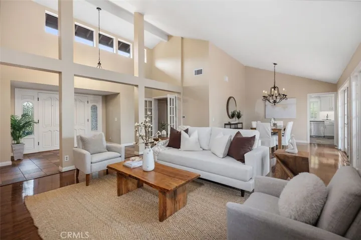 Living room with view to the front door and formal dining area.