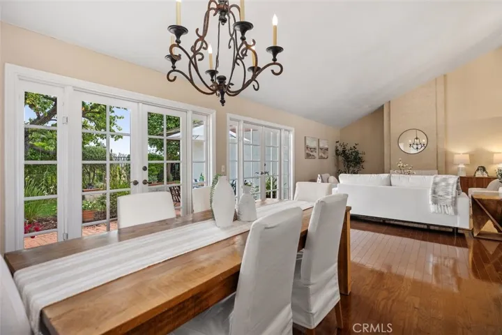 Formal dining area with french doors leading outside to one of the patio gardens.