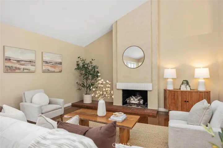 Living room with vaulted ceilings and fireplace.