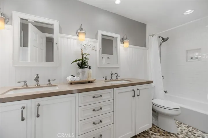 Guest bathroom #2 with dual vanity areas and tub/shower.