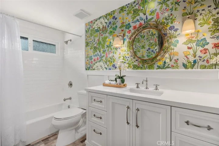 Guest bathroom #1 has a touch of floral accents.