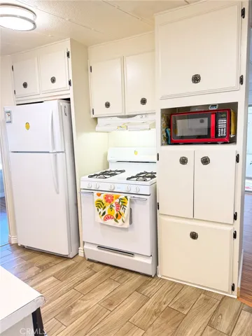 Kitchen refrigerator, stove, microwave, storage