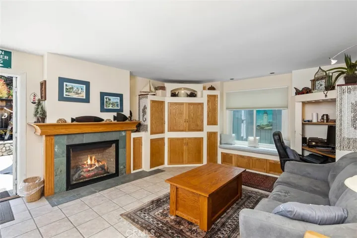 Family Room with Tile Floors and Fireaplce. Open to Backyard