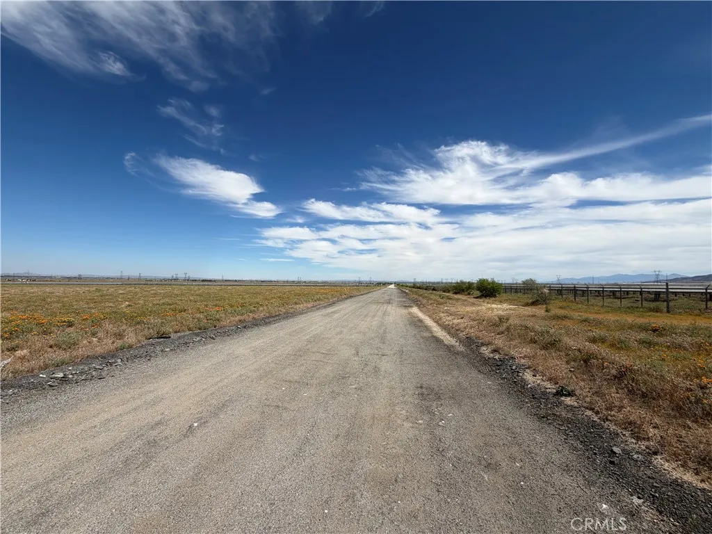 Paved road access with open desert views.