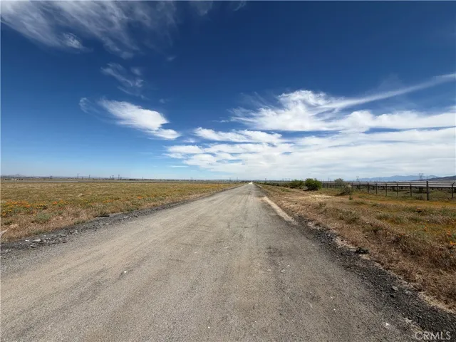 Paved road access with open desert views.