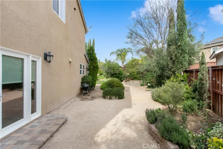 Side yard off of Dining Room w/ French Doors. Can use extra roll of turf in this area or continue with the DG and create another beautiful sitting/entertainment area.