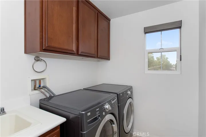 Upstairs laundry with sink. Washer/Dryer included w/ sale of house