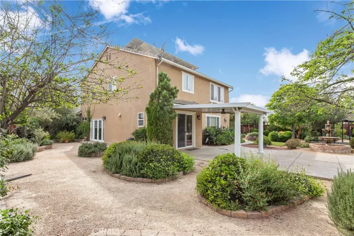 Side angle of home showing the mature landscape and open areas to enjoy