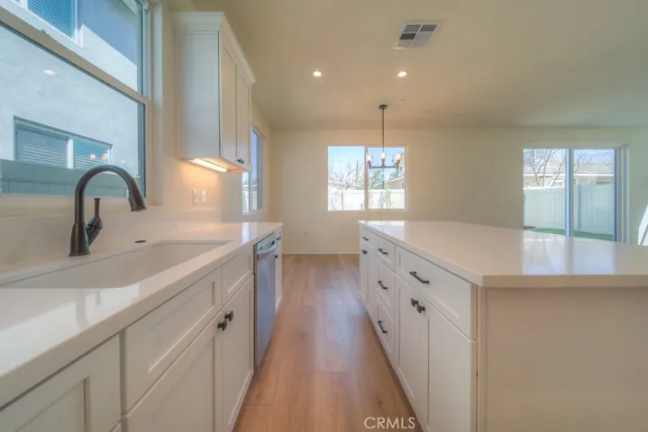 Black hardware finishes, including light fixtures, doorknobs, and handles, are featured throughout the entire home.