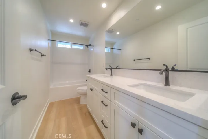 Beautiful third bathroom on the second floor with quartz countertops, black hardware, and real wood soft-close cabinetry.
