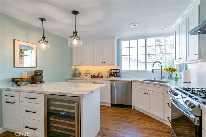 Spectacular remodeled kitchen! Wine fridge, under cabinet lighting, quartz countertops, Samsung suite of appliances, al new soft-close cabinets/drawers