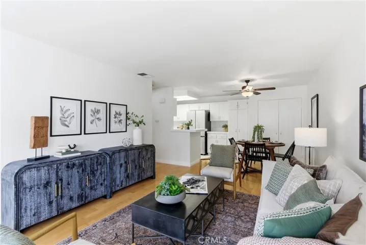 Ceiling fan and lots of storage in the dining area at the end of the photo.