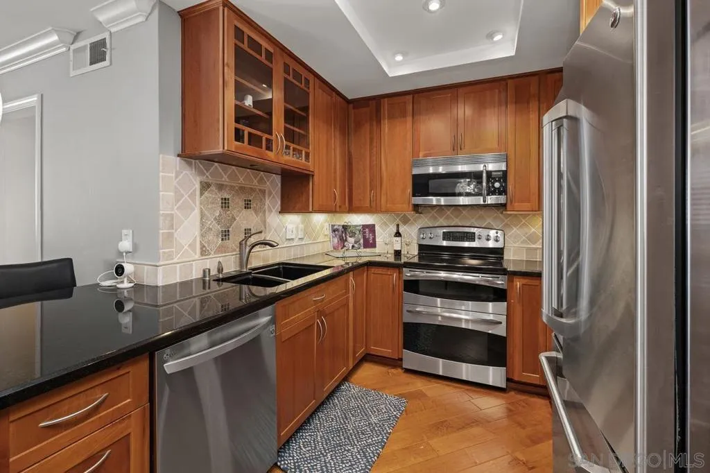 Sleek granite counters with a decorative tile backsplash.