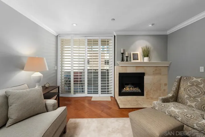 Spacious living room for entertaining. Elegant Plantation shutters and dual pane sliding door.