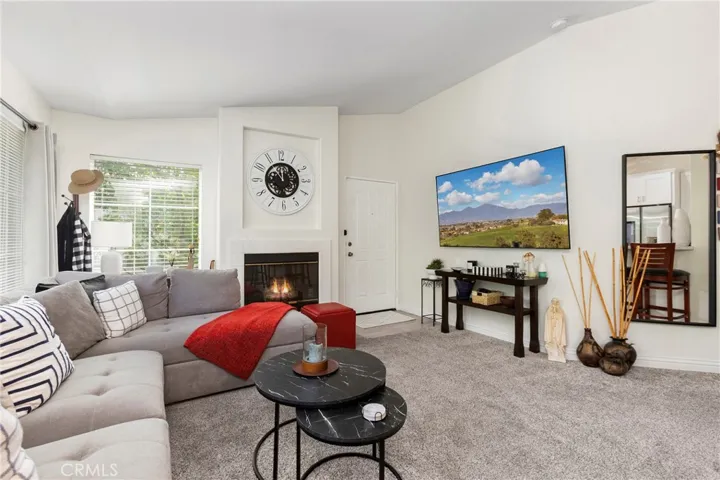 Living room with a fireplace and a large TV wall