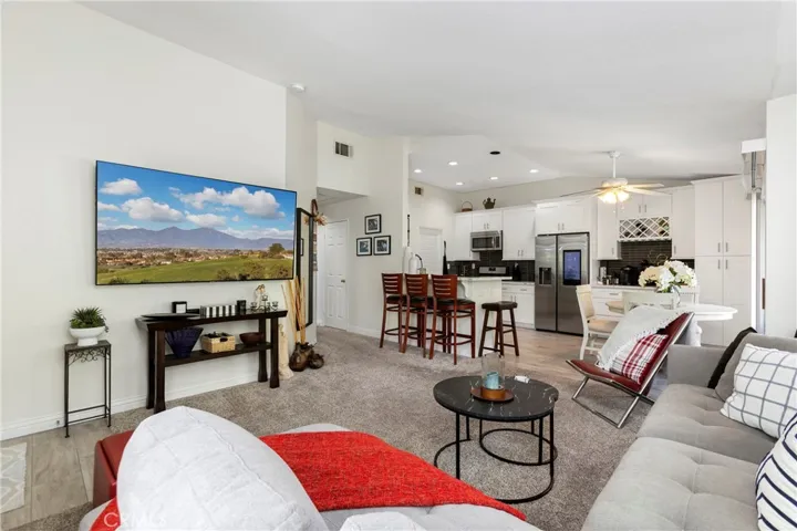 Living room with a fireplace and a large TV wall