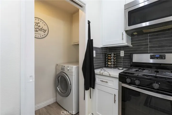 Separate laundry room for full size machines, hidden with a pocket door!